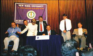 Governor Pataki signing into law legislation to establish a Spinal Cord Injury Research Board and Trust Fund, July 14, 1998. Joining the Governor are (left to right) Officer Steven McDonald, NYPD; Assemblyman Samuel Colman; Mrs. Steven McDonald; Paul Richter, NYS Police Sergeant (Ret.)and also NYS Coordinator, Spinal Cord Society; Matthew Reeve and his Father Christopher Reeve.